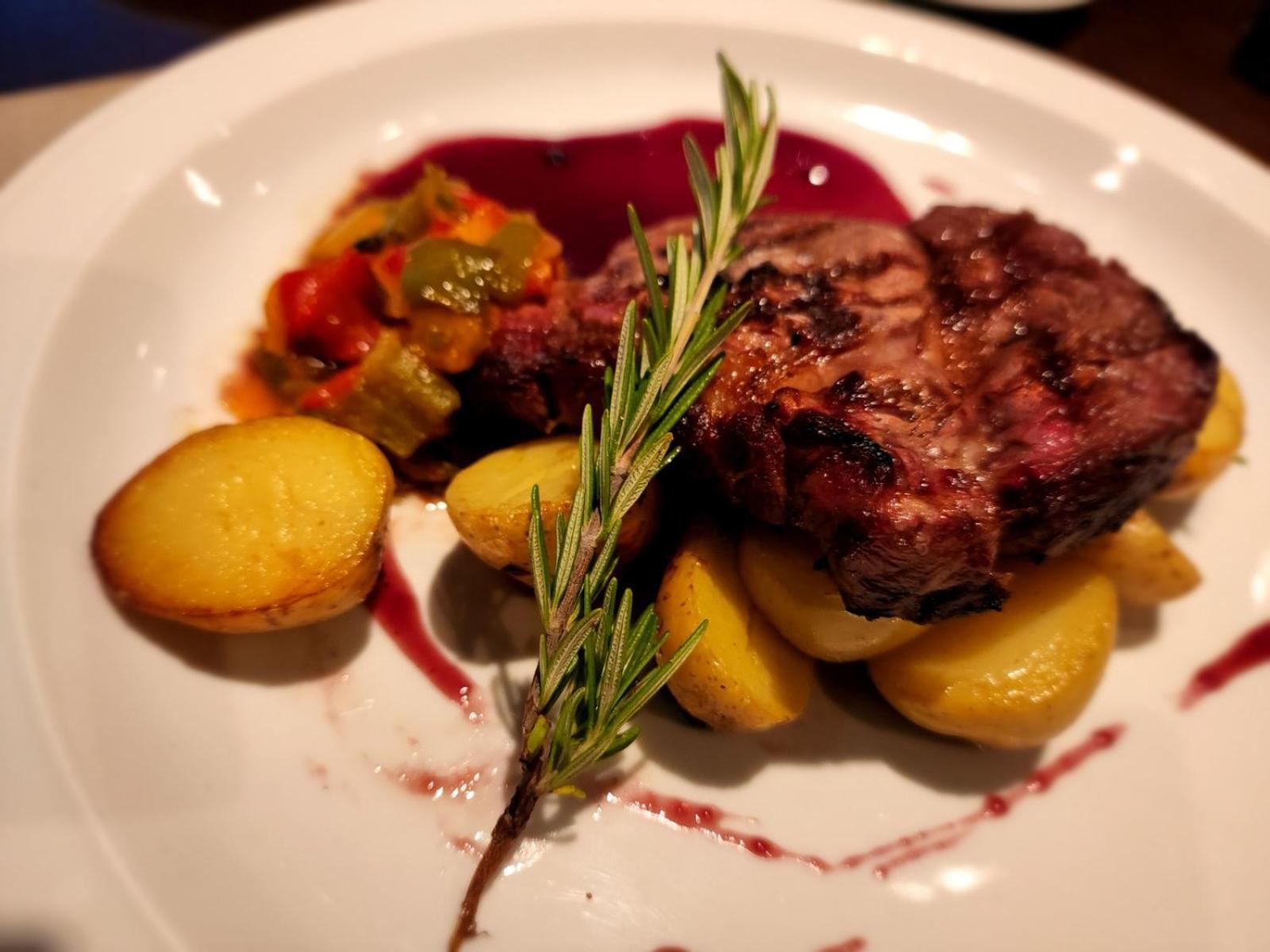 Regal Pacific Puerto Madero Hotel Buenos Aires Eksteriør billede A steak prepared with a sprig of rosemary